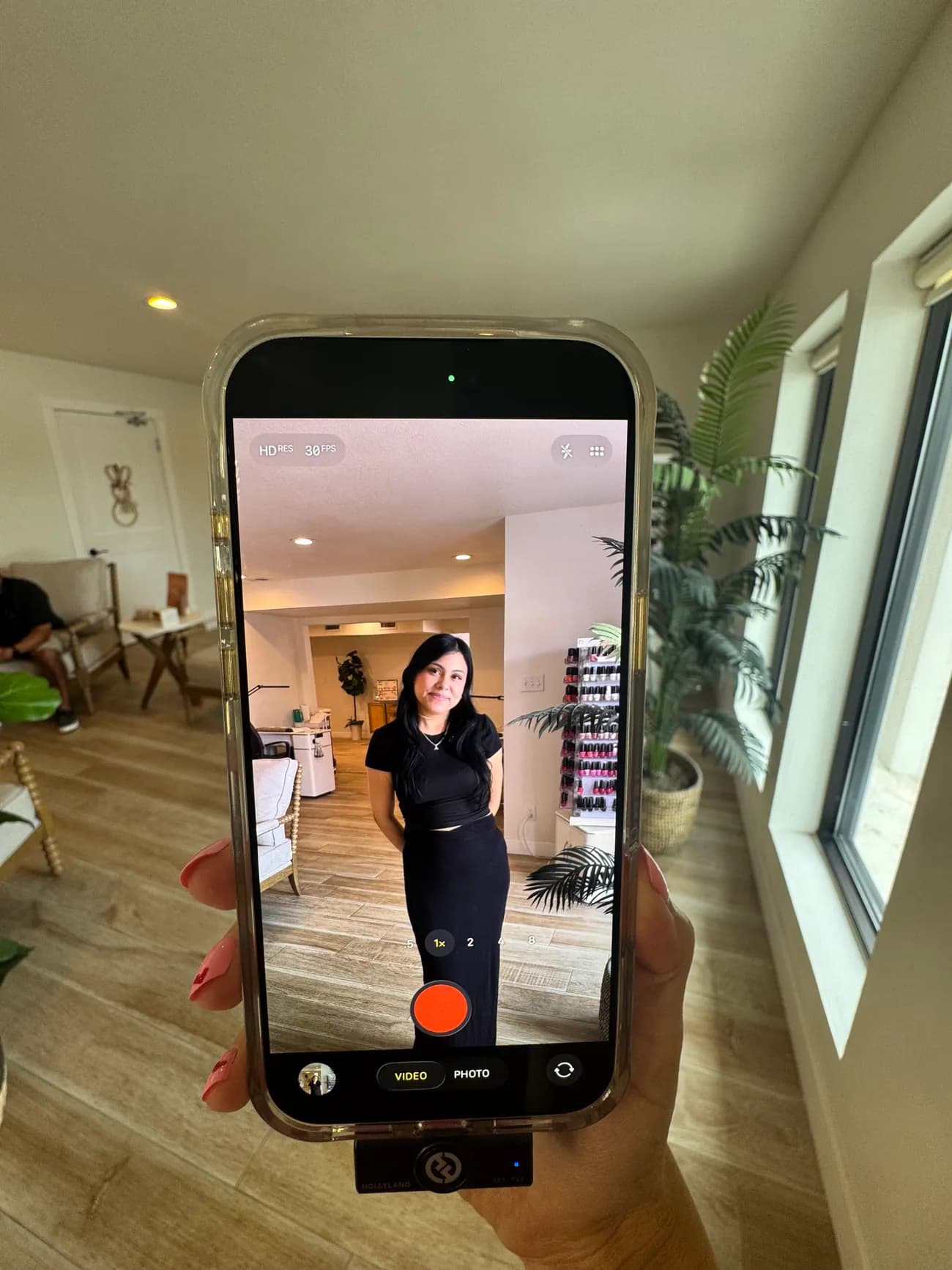 Jaclyn filming a reel with her phone mounted on a tripod