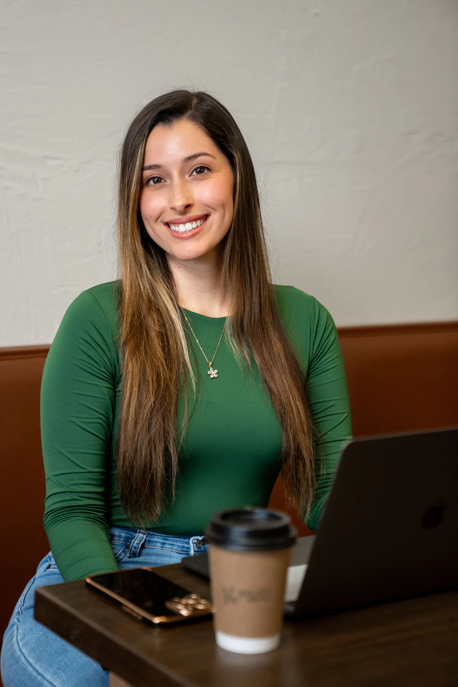 Jaclyn, founder of Drift & Bloom, in a green dress